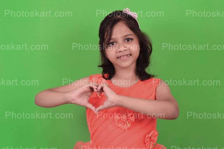 DG33024360922, indian cute girl posing love sign with her hands, indian girl, cute, cute indian girl, red dress, beautiful dress, smart indian girl, beautiful indian girl, girl, green screen, green background, royaltyfree stock image, photoskart, stock image, stock photo, stock photos, posing, indoor, indoor photoshoot, indoor stock image, bachcha meye, meye, cute meye, bengali girl, bangla meye, bengali meye, new dress, cute posing, clever girl