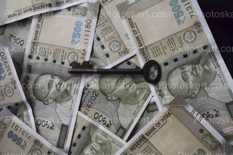 indian-five-hundred-rupees-with-a-old-key-stock-image