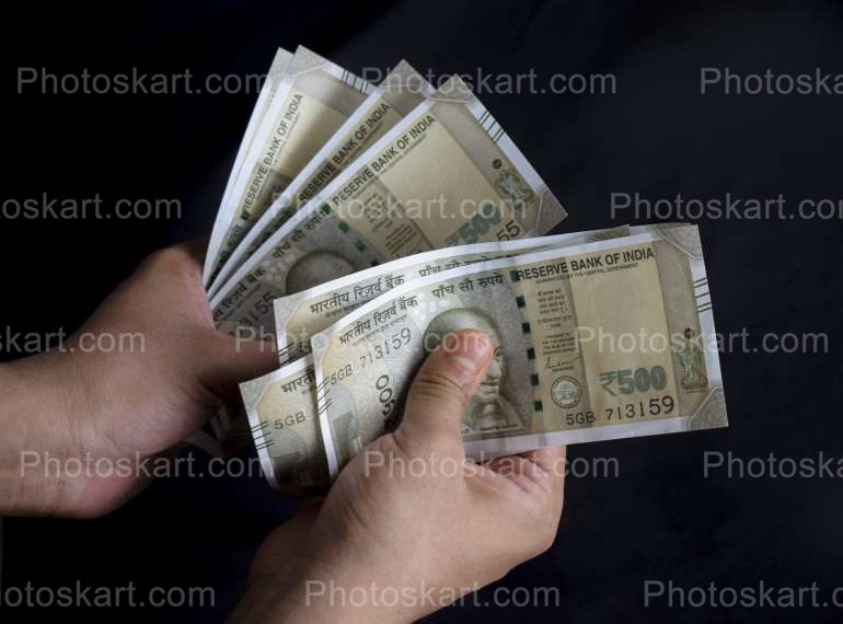 Seven Five Hundred Note Holding By Hand Image